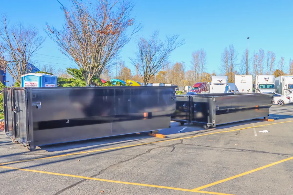 Professional dumpster rental service with roll-off container on residential driveway in Altadena